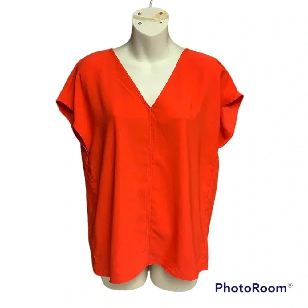 Rachel Zoe bright orange blouse size Small bold seam down the front